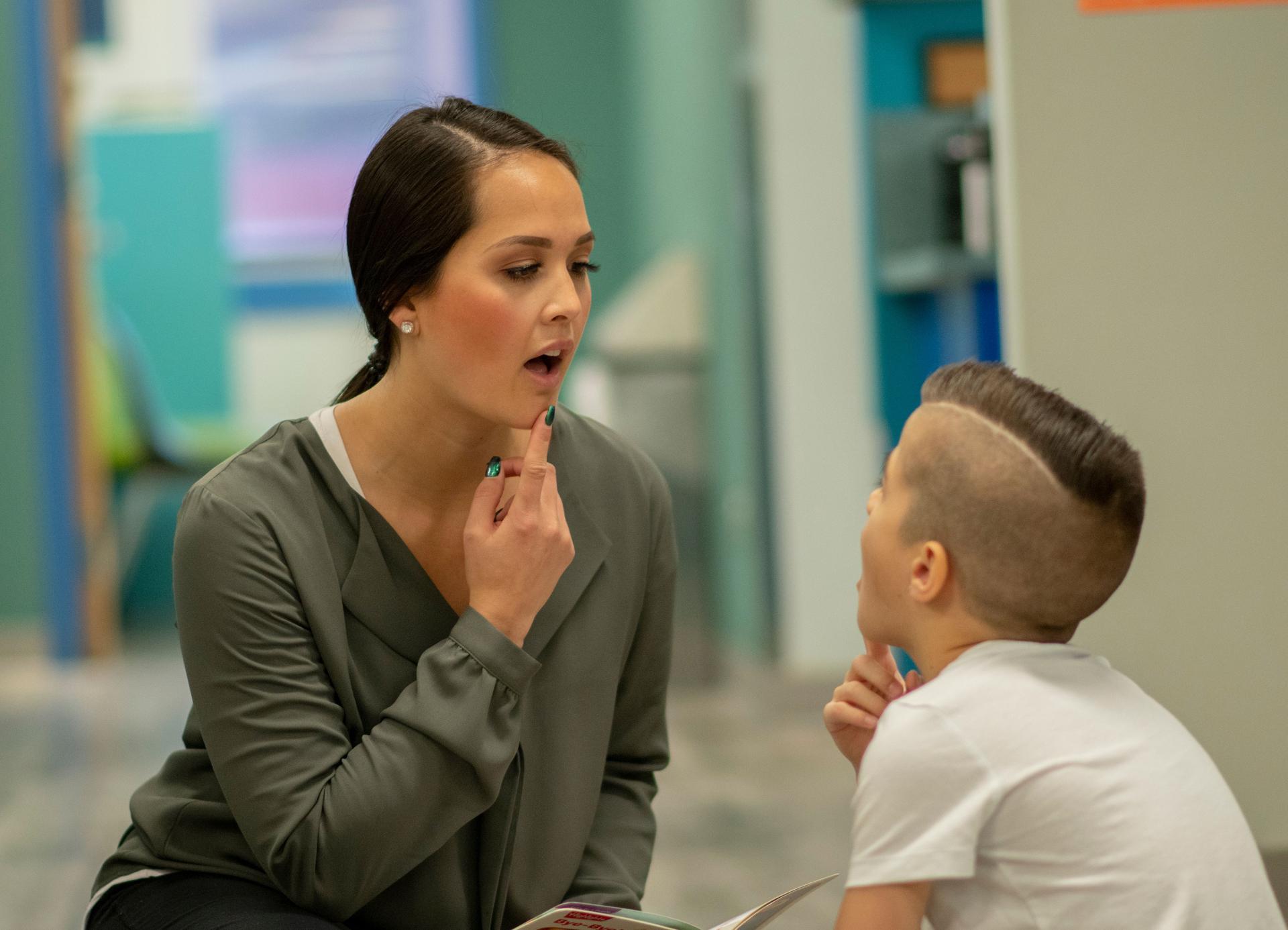 Speech therapist sitting with a child